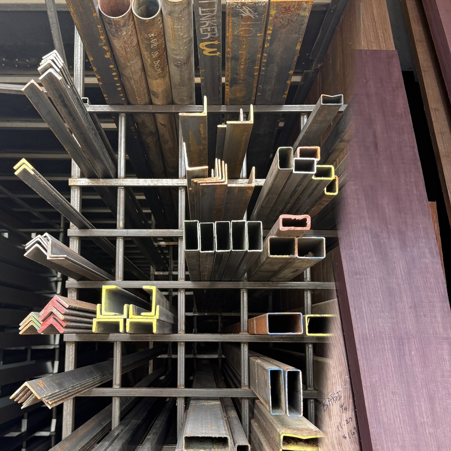 Steel angle, tube and pipe alongside hardwood and exotic lumber in stock at TWI
